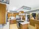 Spacious kitchen with a central island, warm wood cabinets, and a stainless steel refrigerator at 2000 Hawthorne Dr, Plainfield, IN 46168
