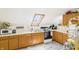 Functional kitchen featuring wood cabinets, skylight, and essential appliances, providing a cozy cooking space at 2000 Hawthorne Dr, Plainfield, IN 46168