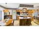 Traditional kitchen with wood cabinetry, a central island, and stainless steel appliances at 2000 Hawthorne Dr, Plainfield, IN 46168