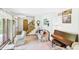 Cozy living room with staircase, classic piano, and ample natural light from a large window at 2000 Hawthorne Dr, Plainfield, IN 46168