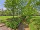 View of backyard showing creek running through a beautiful grassy yard at 2000 Hawthorne Dr, Plainfield, IN 46168