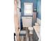 Stylish bathroom featuring a shower with a white tile surround, blue accent rug and coastal decor at 206 Olive St, Arcadia, IN 46030