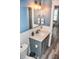 Charming bathroom with a gray vanity, quartz countertop, modern lighting, and coastal-themed decor at 206 Olive St, Arcadia, IN 46030