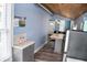 Open-concept kitchen with an eat-in island, stainless appliances, and gray cabinets at 206 Olive St, Arcadia, IN 46030