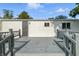 Picture of the back of the house showing the yard and a deck with a door and a window at 212 N 13Th St, Elwood, IN 46036