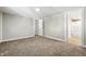 Vacant bedroom features neutral carpeting, a spacious layout, and an attached bathroom at 212 N 13Th St, Elwood, IN 46036