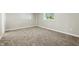 Empty bedroom with neutral carpet and walls featuring natural light from a window at 212 N 13Th St, Elwood, IN 46036