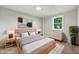 Stylishly staged bedroom featuring neutral colors, contemporary artwork, and lots of natural light at 212 N 13Th St, Elwood, IN 46036