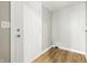 A simple entryway features neutral colors, wood-look flooring, and a bright white door at 212 N 13Th St, Elwood, IN 46036