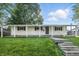 Well-maintained home featuring a classic design, front lawn, and inviting curb appeal at 212 N 13Th St, Elwood, IN 46036