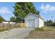 Detached one-car garage with a clean white exterior and ample parking space in the back yard at 212 N 13Th St, Elwood, IN 46036