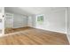 Sunlit living room showcasing beautiful hardwood floors and a fresh, clean aesthetic at 212 N 13Th St, Elwood, IN 46036