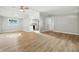 Open-concept living area with hardwood floors, ceiling fan, and seamless flow to the kitchen at 212 N 13Th St, Elwood, IN 46036