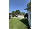 Backyard features a detached shed, overgrown grass, and view of the home's siding at 2215 Noble St, Anderson, IN 46016