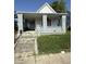 Street view of a single Gathering home, with a covered porch and weathered facade at 2215 Noble St, Anderson, IN 46016