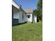 Side view of a single Gathering home, showing peeling paint and a green lawn at 2215 Noble St, Anderson, IN 46016