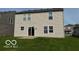 View of the home's rear facade showing access to the backyard and green space at 2230 Cedarmill Dr, Franklin, IN 46131