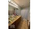 Bathroom featuring double vanity with glass sinks and ample storage beneath at 2230 Cedarmill Dr, Franklin, IN 46131