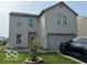 Two-story home featuring a large garage, trimmed windows, and a manicured lawn at 2230 Cedarmill Dr, Franklin, IN 46131