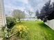 Well-maintained backyard with lush green grass, flowering bushes, mature trees, and a pond with a fountain at 2292 Hampton Dr, Franklin, IN 46131