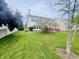 Spacious backyard with a well-manicured lawn, wooden deck, and mature trees, perfect for outdoor enjoyment at 2292 Hampton Dr, Franklin, IN 46131