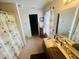 Bright bathroom with a single vanity, beige shower curtain, and decorative 'Love U' message on the mirror at 2292 Hampton Dr, Franklin, IN 46131