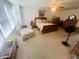 Spacious bedroom with floral accents, including a full bed and an accompanying cushioned lounge chair at 2292 Hampton Dr, Franklin, IN 46131