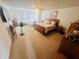 Bright primary bedroom featuring plush carpeting, a ceiling fan, and a cozy sitting area at 2292 Hampton Dr, Franklin, IN 46131
