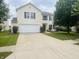 Traditional home with a spacious driveway, two-car garage, and a lush green lawn at 2292 Hampton Dr, Franklin, IN 46131