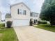 Home features a two-car garage and well-kept lawn in a quiet neighborhood at 2292 Hampton Dr, Franklin, IN 46131