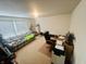 Bright office space with a comfortable plaid couch, rolling desk chair, and a computer setup at 2292 Hampton Dr, Franklin, IN 46131