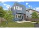 Backyard with patio, gas grill, patio set, string lights, and modern blue siding, complete with full lawn at 2326 Prospect St, Indianapolis, IN 46203