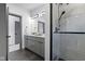 Modern bathroom showcasing a sleek vanity, a large mirror, and a glass-enclosed shower with contemporary fixtures at 2326 Prospect St, Indianapolis, IN 46203