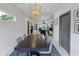 Bright dining area featuring a modern table set, unique light fixture, and an open view to the kitchen at 2326 Prospect St, Indianapolis, IN 46203