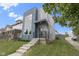 Modern two-story home with blue and gray siding, concrete stairs, and a well-manicured lawn at 2326 Prospect St, Indianapolis, IN 46203