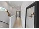 Well-lit hallway featuring hardwood floors, recessed lighting, and a decorative mirror, plus unique wall art at 2326 Prospect St, Indianapolis, IN 46203