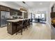 Modern kitchen featuring a large island with seating, stainless steel appliances, and an open dining area at 2326 Prospect St, Indianapolis, IN 46203