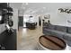 Open-concept living space featuring a kitchen island, light wood floors, and a gray sofa at 2326 Prospect St, Indianapolis, IN 46203