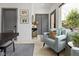 Inviting sitting area with a comfortable armchair, stylish decor, and natural light streaming through the window at 2326 Prospect St, Indianapolis, IN 46203