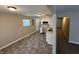 Open-concept kitchen featuring white cabinets, vinyl flooring, and ample natural light at 2354 Collier St, Indianapolis, IN 46241