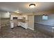 Well-lit kitchen features white cabinets, laminate counters, and vinyl flooring at 2354 Collier St, Indianapolis, IN 46241