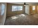 Bright living room features neutral walls, ceiling fan, and plush carpeting at 2354 Collier St, Indianapolis, IN 46241