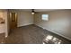 Bright living room features neutral walls, ceiling fan, and plush carpeting at 2354 Collier St, Indianapolis, IN 46241