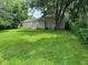 View of the home from the backyard showing the sliding glass door and a spacious yard at 2626 Fairhaven Dr, Indianapolis, IN 46229