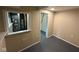 Finished basement room featuring painted walls, new flooring, and a pass-through window to utilities at 2626 Fairhaven Dr, Indianapolis, IN 46229