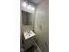 Bathroom with a sleek mirror, modern lighting, and compact vanity at 2626 Fairhaven Dr, Indianapolis, IN 46229