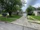 View of home from street, showing tan siding, 1-car garage, and front yard at 2626 Fairhaven Dr, Indianapolis, IN 46229