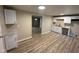 Charming kitchen featuring white cabinets, laminate flooring and a sink with white countertops at 2626 Fairhaven Dr, Indianapolis, IN 46229