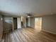 Open living room featuring laminate flooring, a ceiling fan, and easy access to the stairway at 2626 Fairhaven Dr, Indianapolis, IN 46229