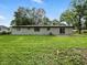 Spacious backyard featuring a home with white brick exterior and a well-maintained lawn at 2853 S State Ave, Indianapolis, IN 46203